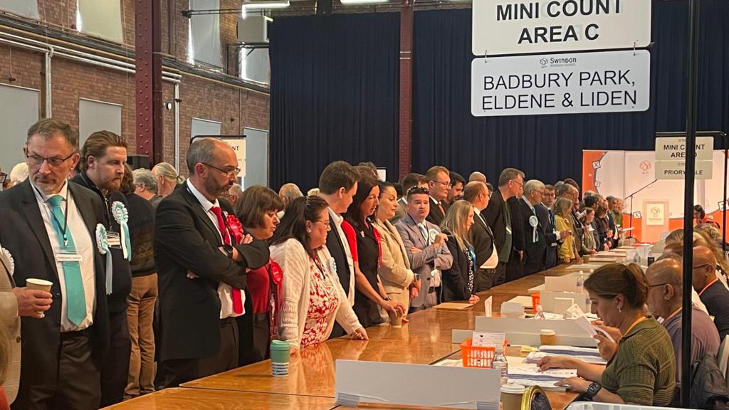 People standing around a table at an election count
