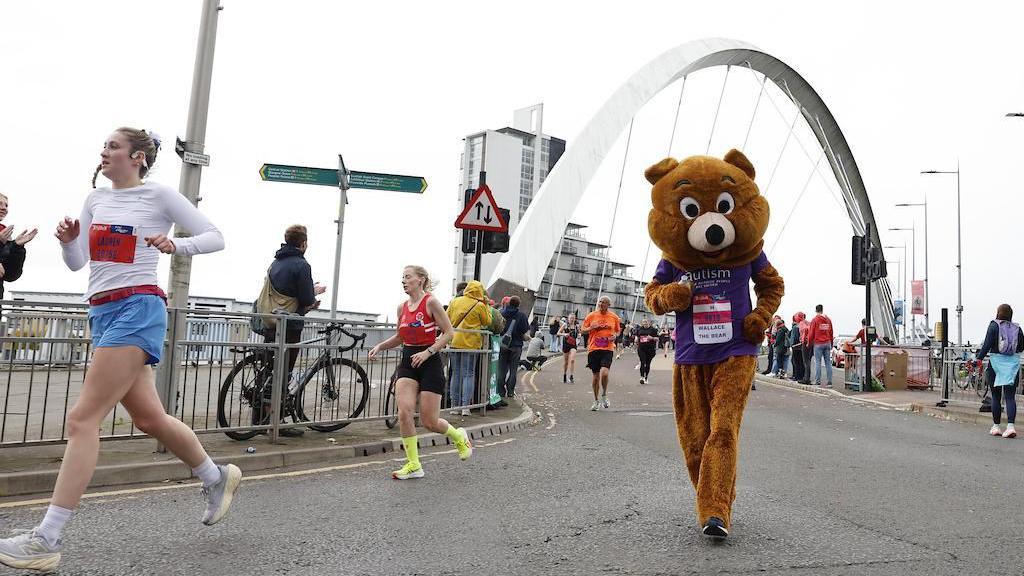 A person running dresses as a bear