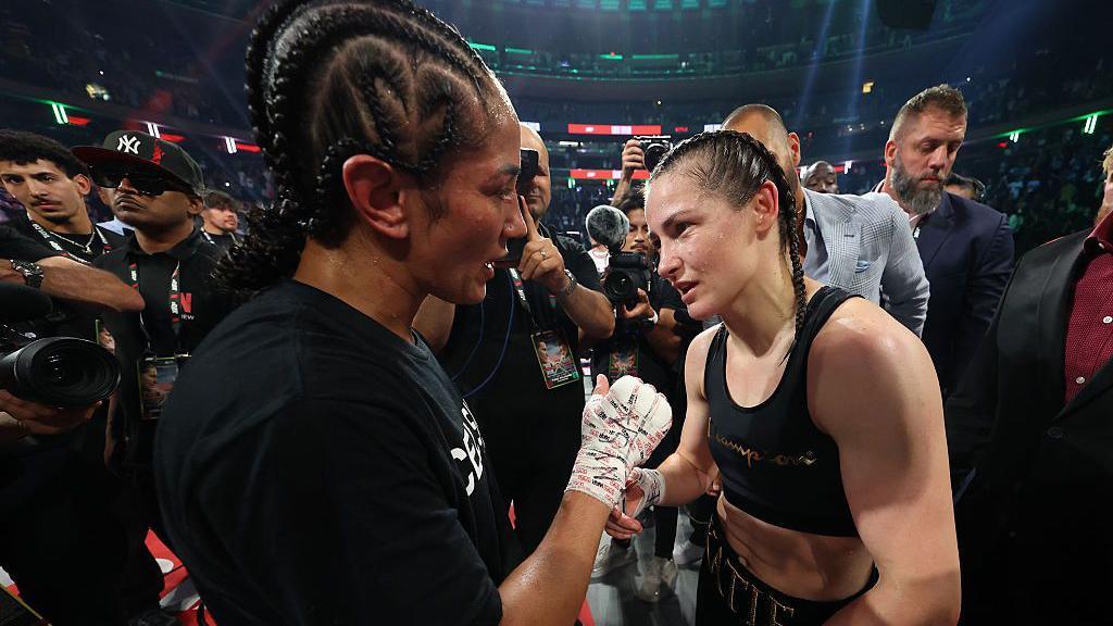 Amanda Serrano and Katie Taylor speak in the ring after their fight