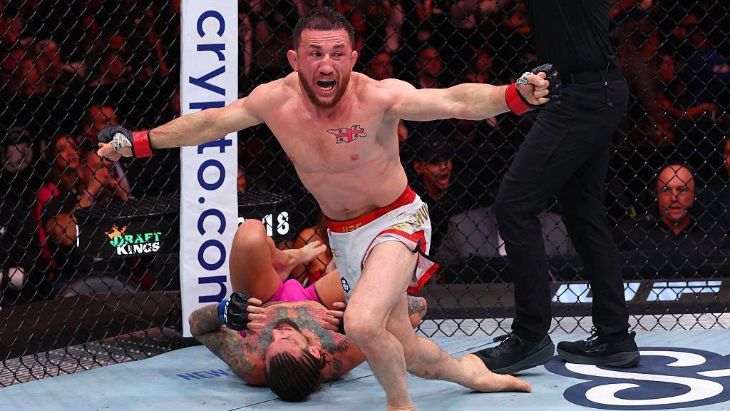 Merab Dvalishvili celebrates with Sean O'Malley on the ground