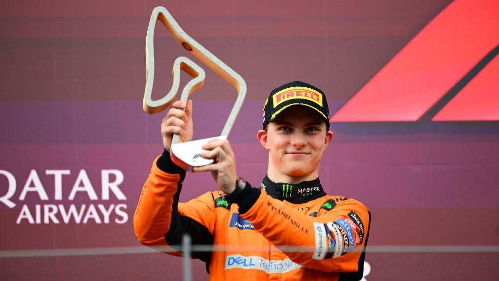 Oscar Piastri holds his trophy on the podium in Austria 