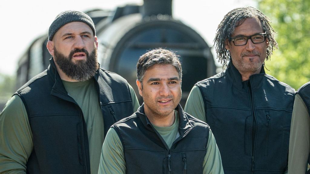 Joe Marler,  Nick Mohammed, David Olusoga in front of a train 