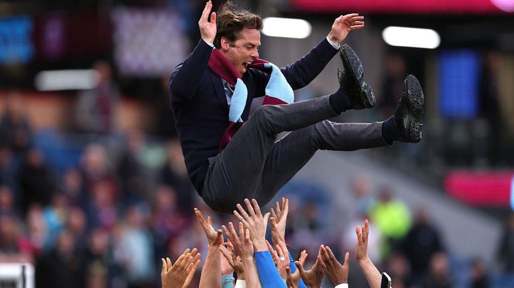 Burnley players throw manager Scott Parker into the air as they celebrate promotion following the win over Sheffield United