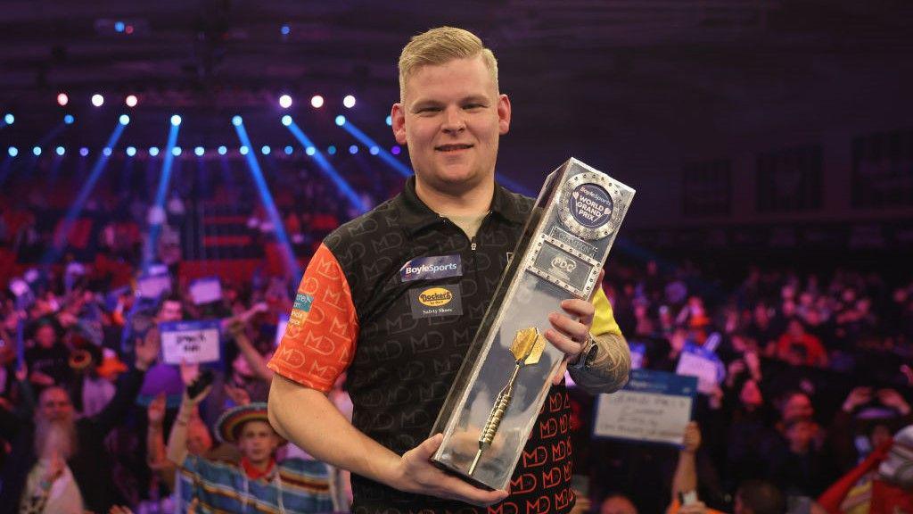Mike De Decker holding the World Grand Prix trophy