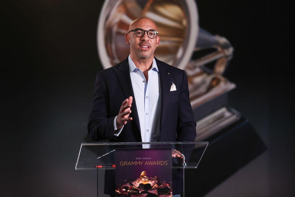 Harvey Mason, Jr standing at a podium in a jacket and shirt 