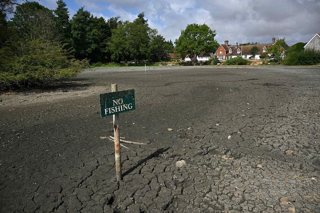 A 'No Fishing' sign is pictured in the dried up Falmer Pond in Falmer, East Sussex, south of London