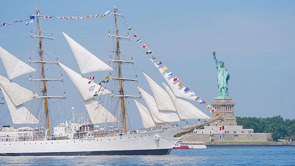 A tall ship sailing past the Statue of Liberty to celebrate America's 250th birthday, in New York.