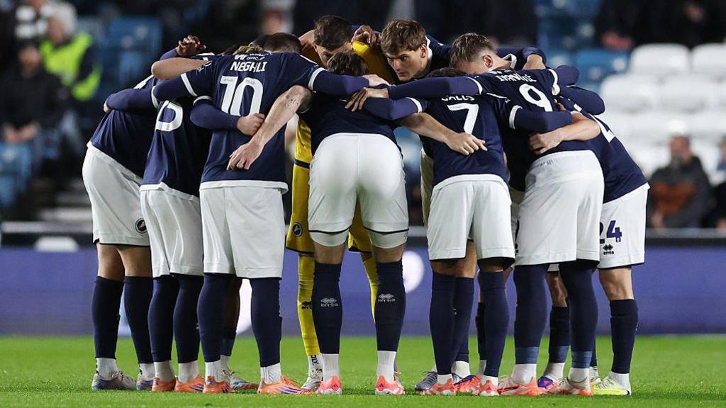 Millwall players in a pre-match huddle