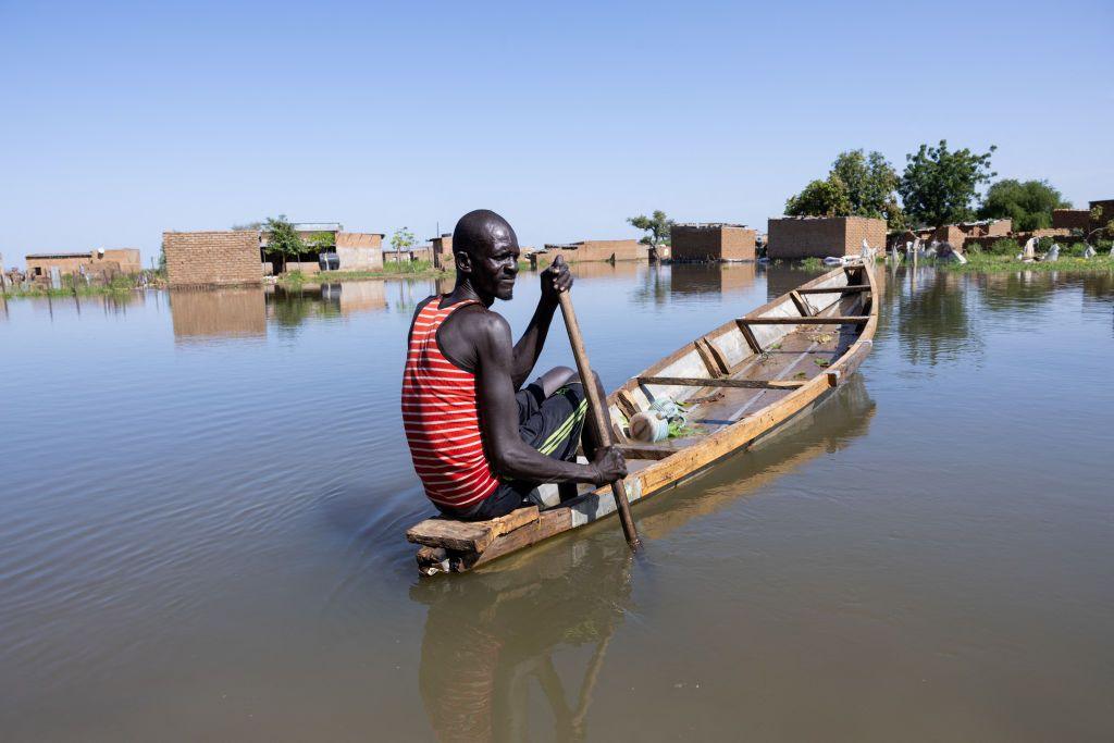 A man navigates a pirogue between the houses of the Tougoude district, in the south-east of Ndjamena's ninth arrondissement, flooded by the Logone River.