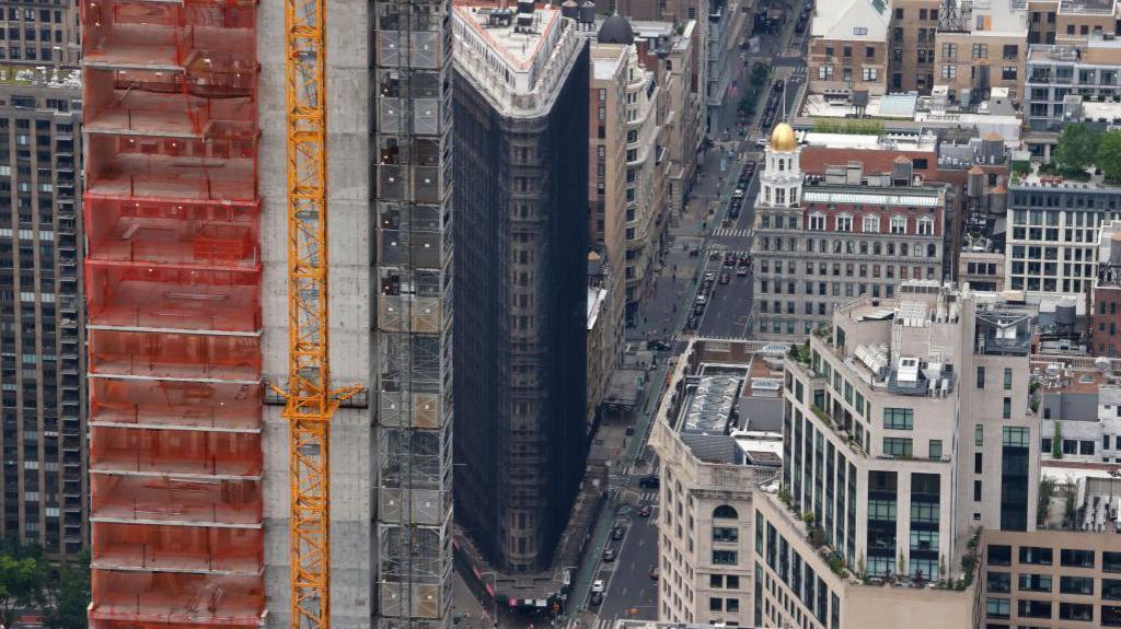 Aerial view of the building covered in dark material