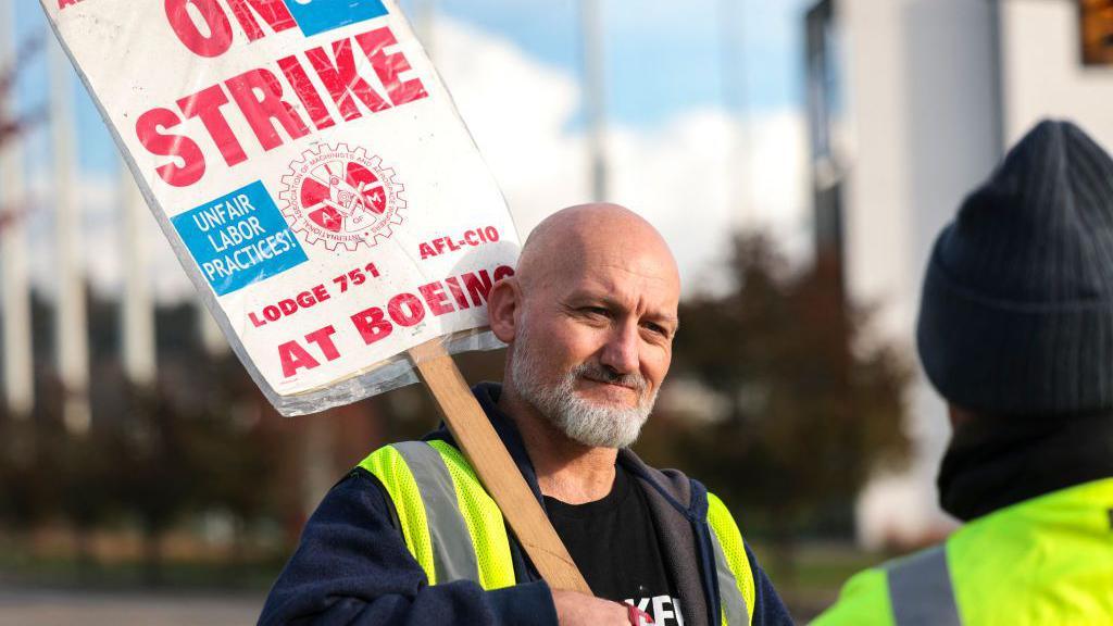 Boeing machinist Andre Johnstone pickets outside the Renton Production Facility. 