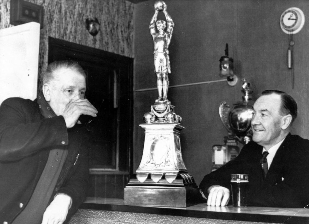  Sid Douthwaite (right), secretary of West Auckland Football Club, with the World Cup in the bar of the Eden Arms, West Auckland, County Durham.
