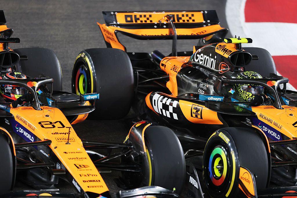 A close-up image of Lando Norris passing McLaren team-mate Oscar Piastri at the start of the Singapore Grand Prix