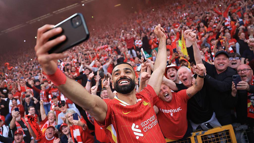 Mo Salah takes a selfie with fans, as they celebrate winning the Premier League title in 2025.