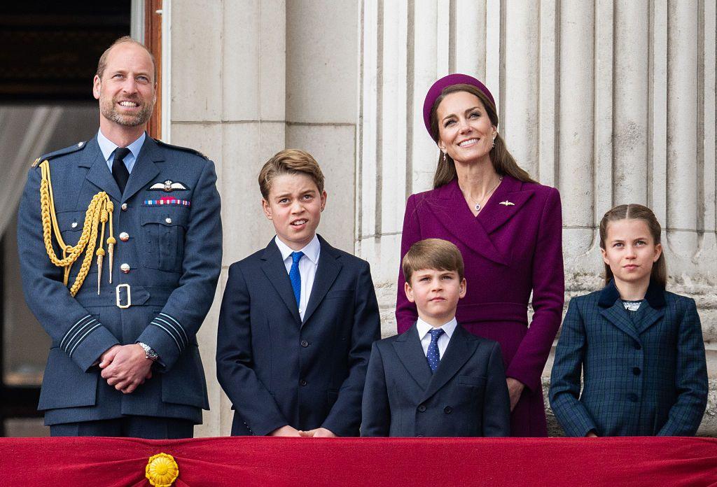 Prince William, Prince George, Catherine, Princess of Wales, Prince Louis and Princess Charlotte watching the flypast for the 80th anniversary of VE Day in May - they are all in formal dress on a balcony outside
