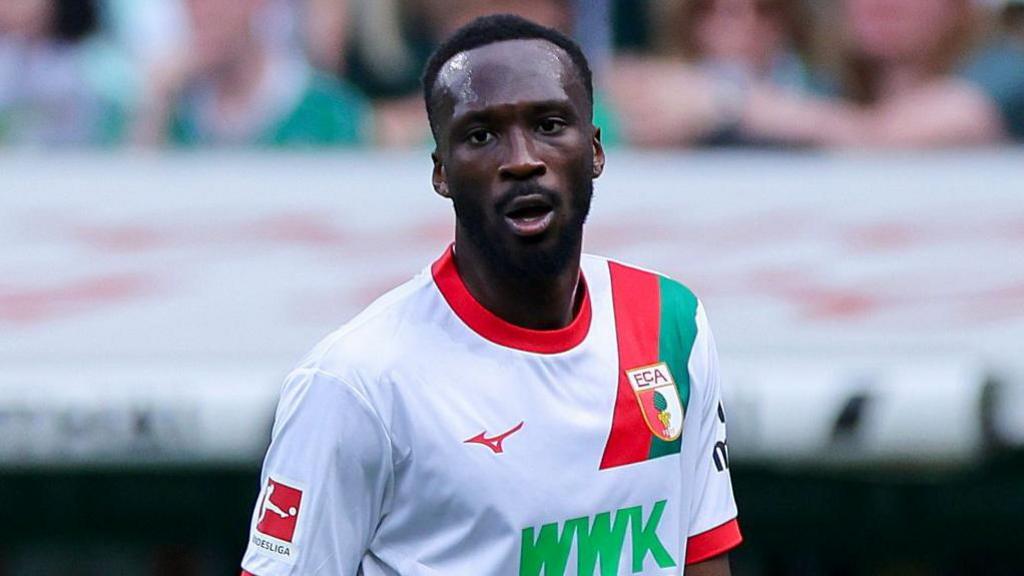 Chrislain Matsima looking tired while playing for Augsburg
