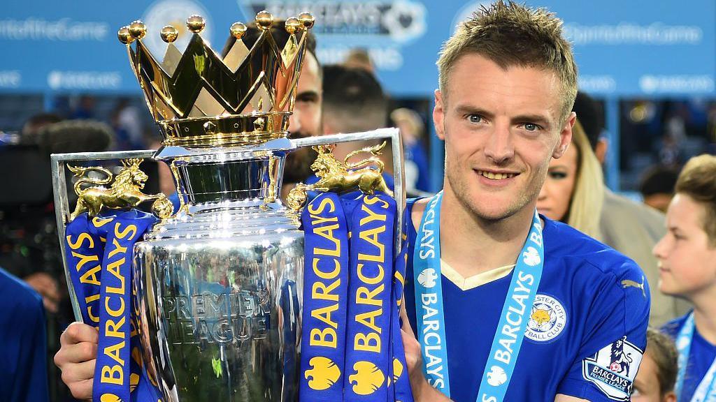 Jamie Vardy of Leicester City poses for photographs with the Premier League Trophy