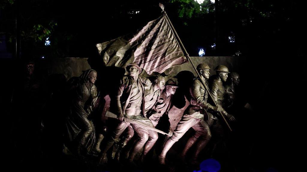 A view of the memorial showing soldiers carrying an American flag