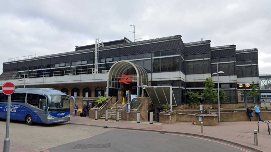 The front of Reading station, with a blue coach to the left 