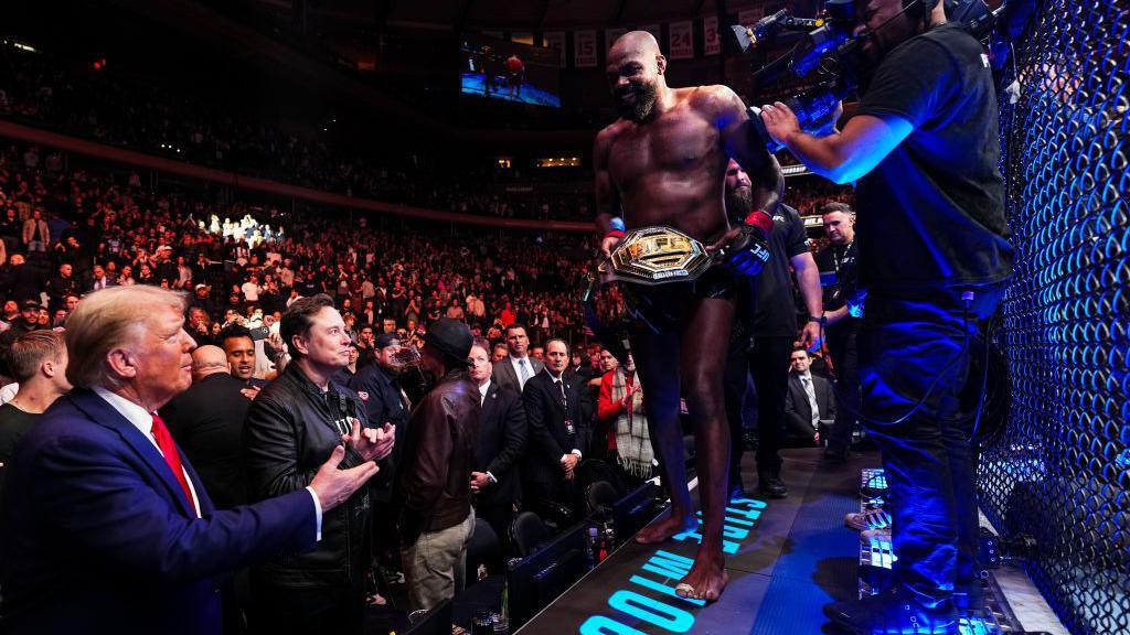 Jon Jones gives the UFC belt to Donald Trump