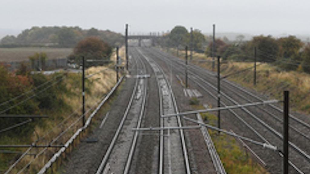 Four main railway lines heading into the distance. It is an overcast day with grey clouds overhead.