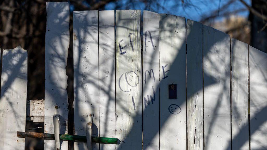 A fence scrawled with the words: "EPA come in!"