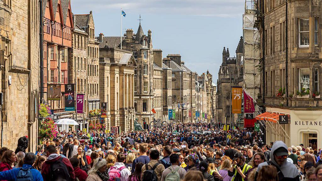 A huge crowd of people at the top of the Royal Mile in Edinburgh