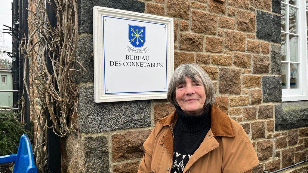 Image of the St Martins Parish Constable, Carla Bauer, outside of St Martins Parish Hall