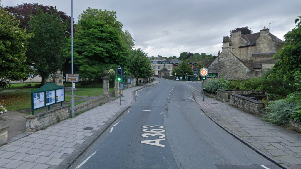 The pedestrian crossing in Bradford-on-Avon. There are slabbed pavements to both sides of the road.