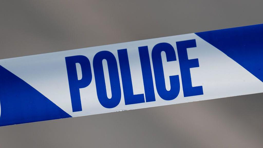 A close-up of blue and white police tape.