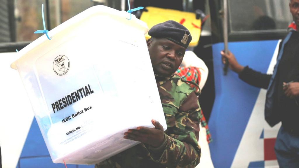 A policeman unloads sealed ballot boxes in Nairobi, Kenya