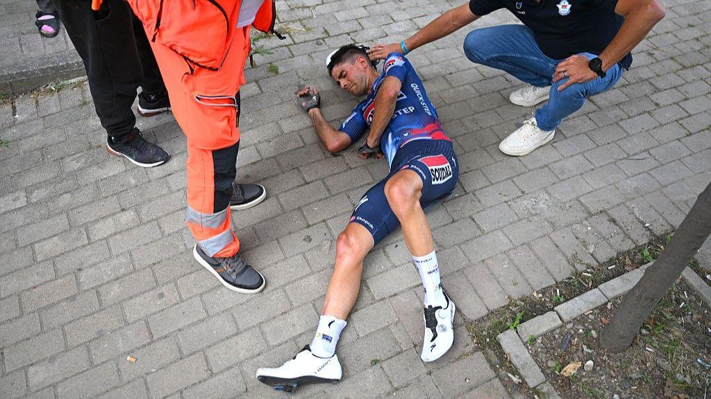 Mikel Landa lies on the ground after a heavy crash during the opening stage of the 2025 Giro d'Italia