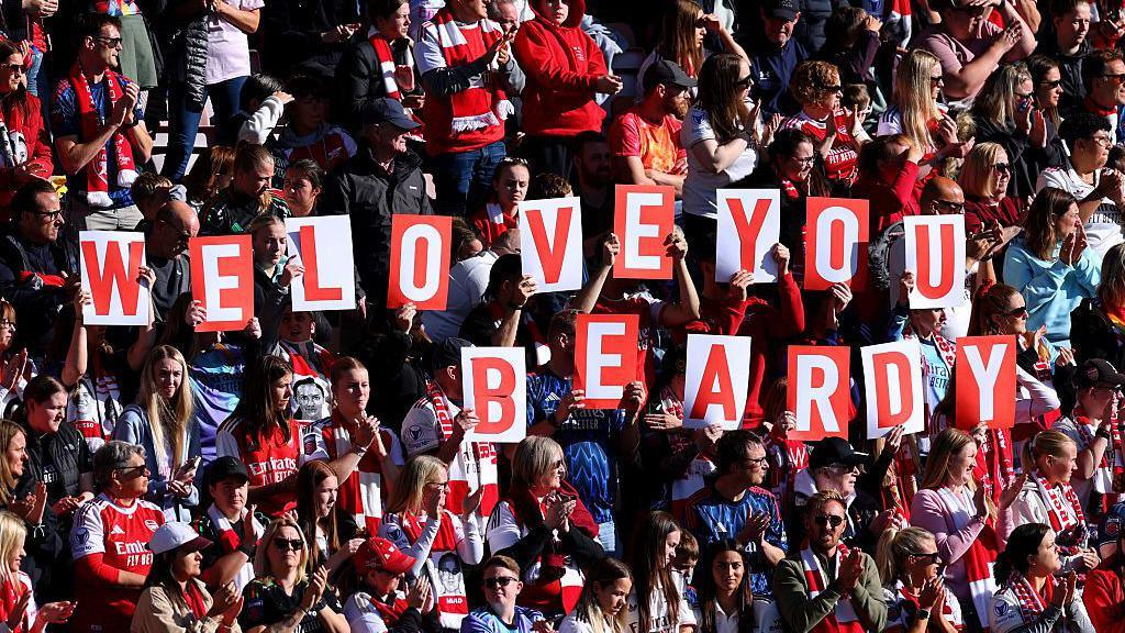 Arsenal fans clasp up 'We emotion you Beardy' signs