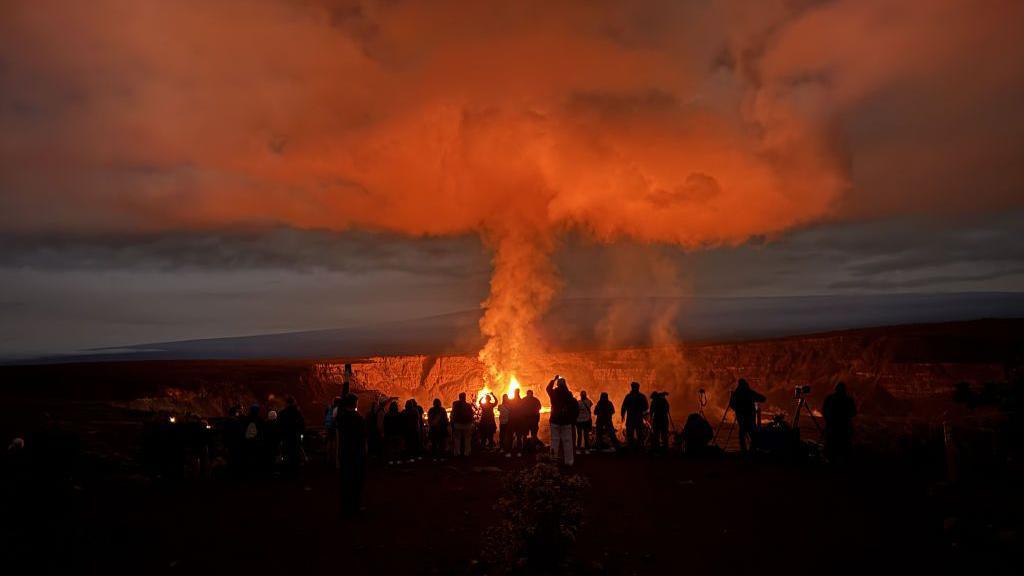 early morning view of visitors gathered at Keanakakoi Overlook in Hawaii Volcanoes National Park to view the ongoing Kilauea eruption.