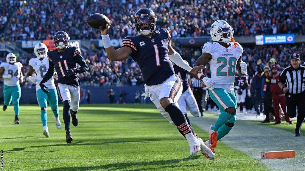 Justin Fields runs in a touchdown against the Miami Dolphins