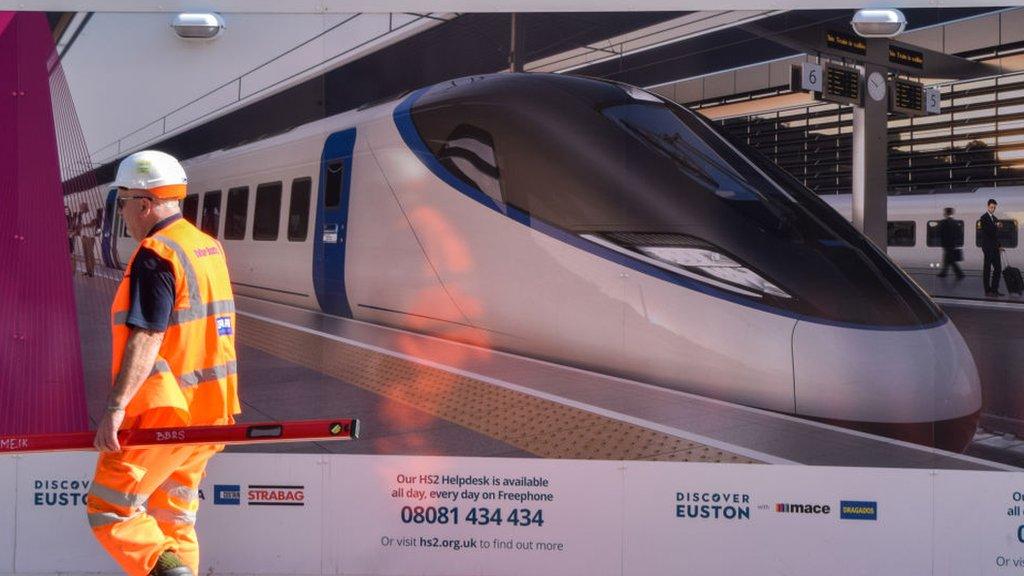 A worker walks outside the HS2 construction site at Euston Station