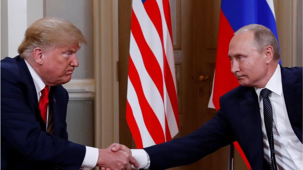 Donald Trump and Vladimir Putin shake hands as the summit begins