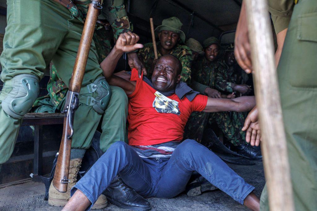 A Kenyan man is held by police officers in a vehicle for demanding the release of government critics abducted in the country - Monday 6 January 2025