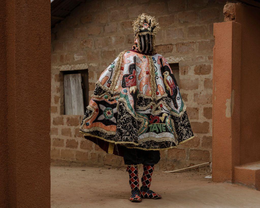 A person wearing a richly textured outfit for the at the annual Voodoo festival in Benin, Ouidah represents the visible manifestation of the spirit of departed ancestors - Thursday 9 January 2025.