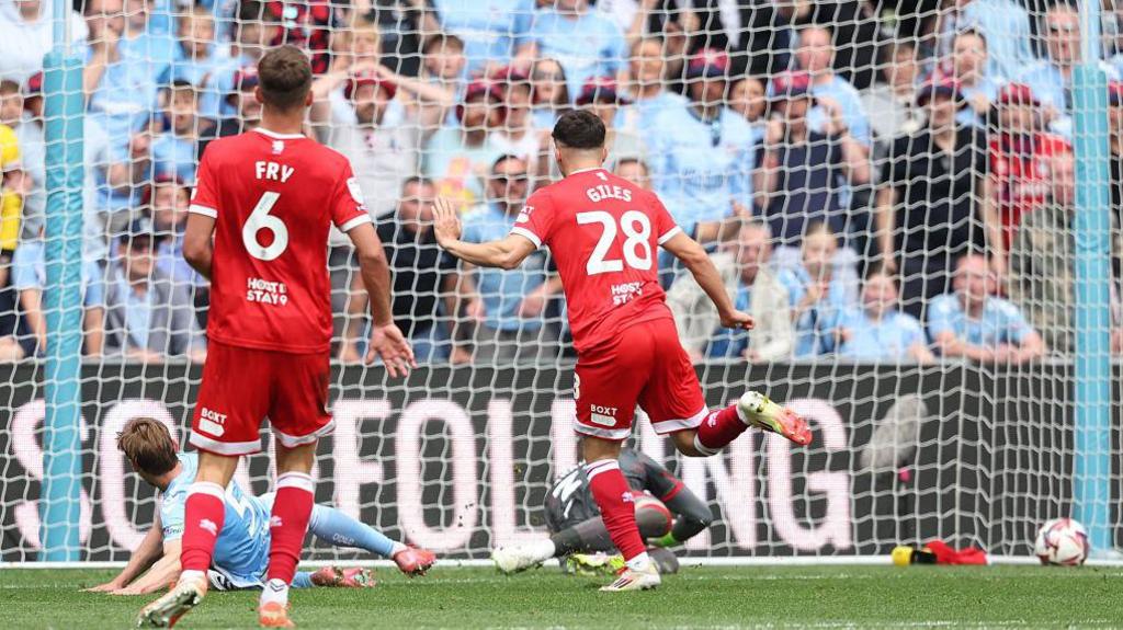 Jack Rudoni slides in Coventry's second goal as Middlesbrough players Dael Fry and Ryan Giles watch on