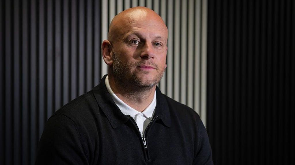 New Barrow manager Adam Murray sits preparing for an interview