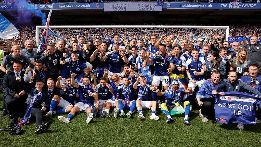 The Ipswich players and staff celebrate their promotion to the Premier League after the EFL Championship