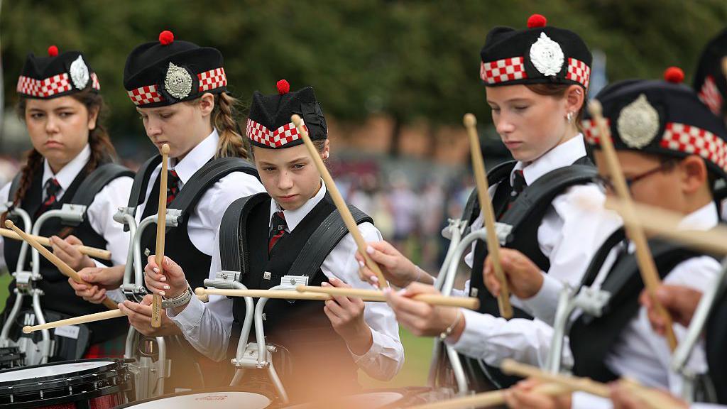 Drummers from Dollar Academy pipe band prepare
