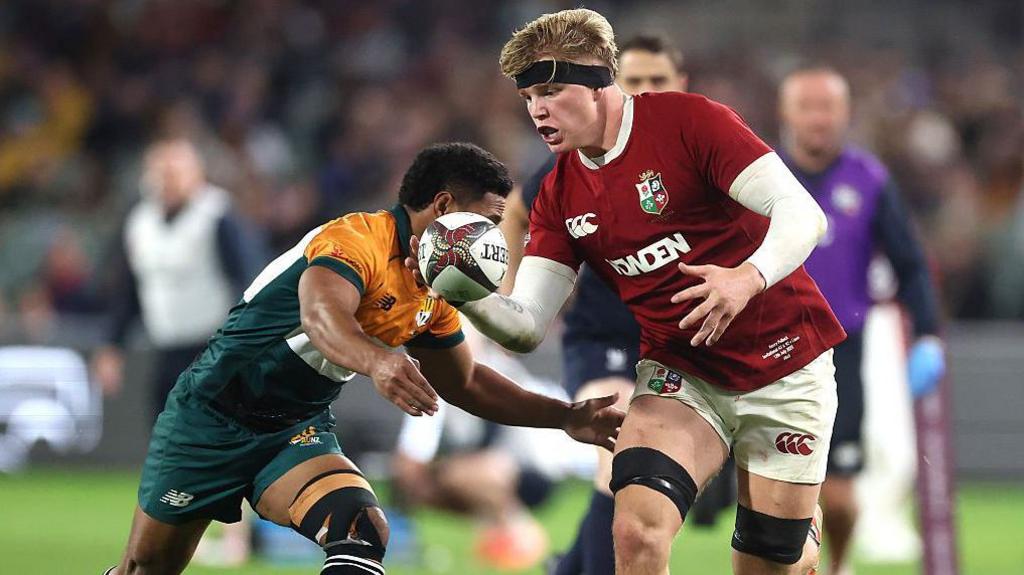 Henry Pollock running with the ball for the Lions in a tour game