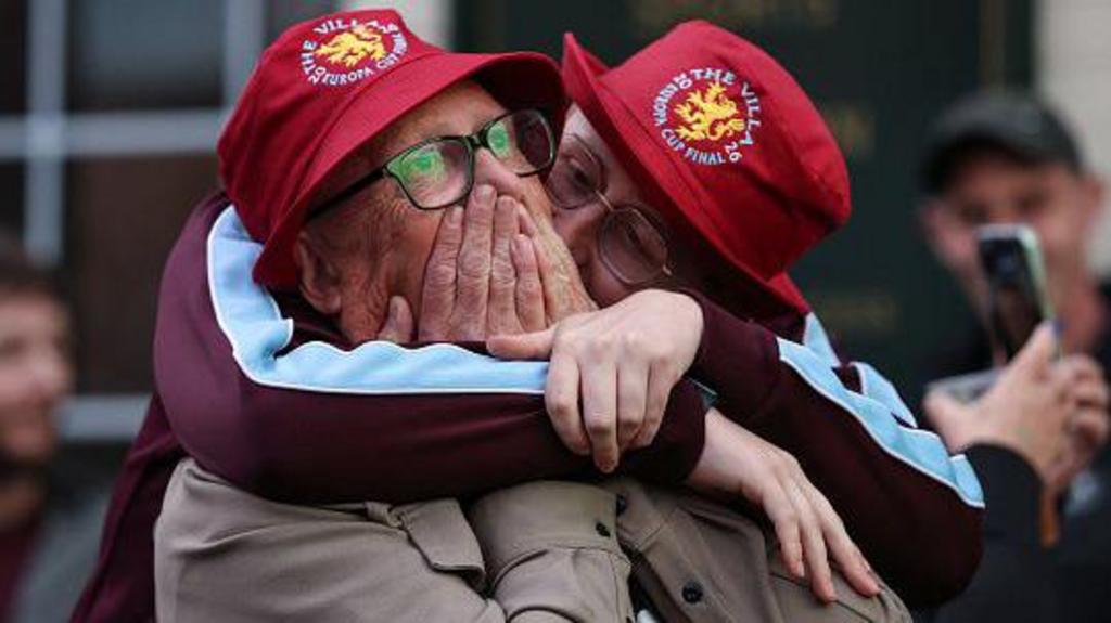Supporters of Aston Villa react as they watch the UEFA Europa League final football match between SC Freiburg and Aston Villa on television outside the Witton Arms pub near Villa Park in Birmingham