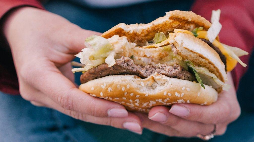 Girl-holding-a-burger