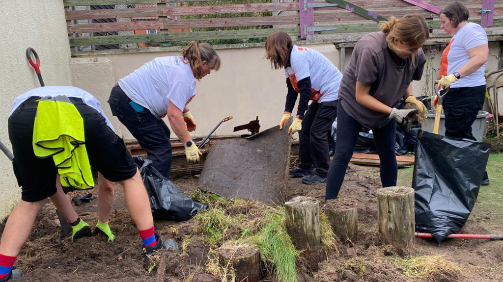 Volunteers are digging and moving the earth into plastic bags