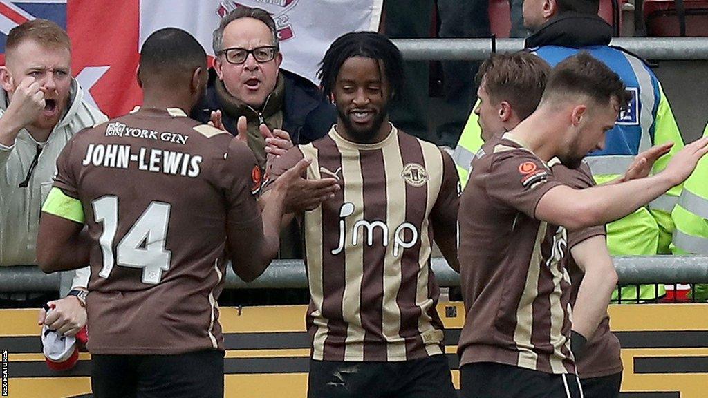 Shaq Forde (centre) celebrates a goal for York City