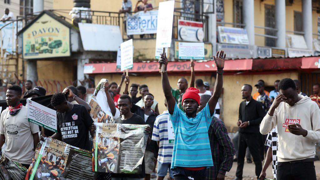 Protesters carry placards during the "Fearless In October" protest in Abuja, Nigeria - 1 October 2024