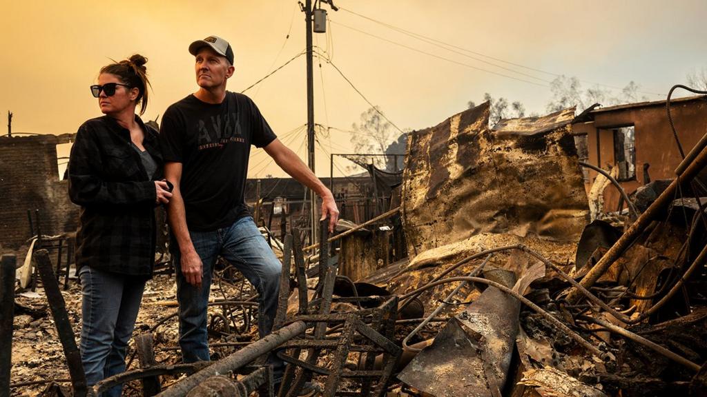  A couple look away from camera as they survey the ruins of their business, the Rancho Bar, which was destroyed by the Eaton Fire in Altadena